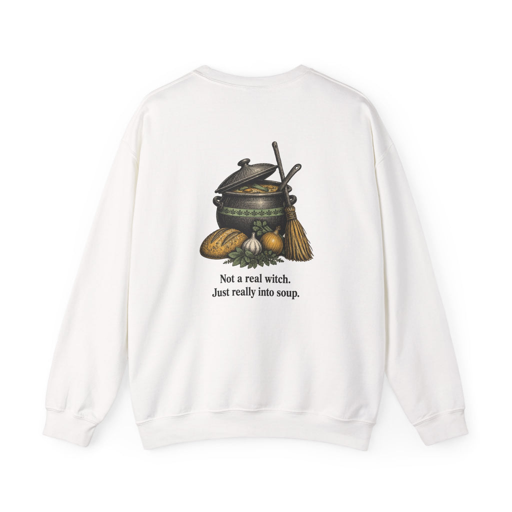 Back of the White Kitchen Witch sweatshirt showing a soup pot and broom and “Not a real witch. Just really into soup.”
