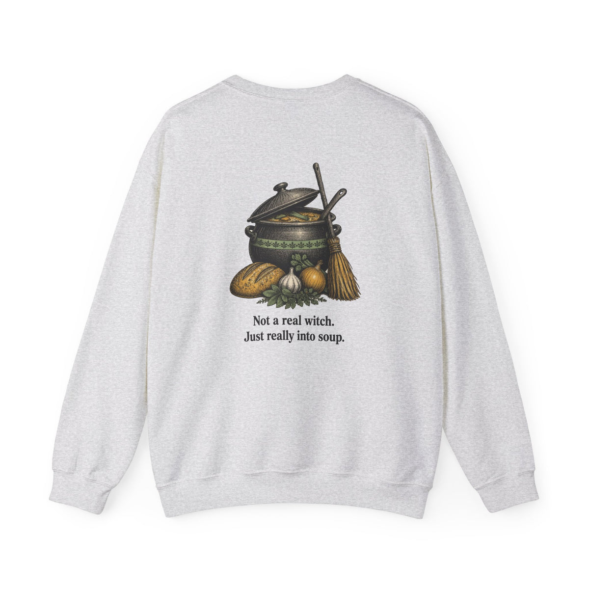 Back of the Ash Kitchen Witch sweatshirt showing a soup pot and broom and “Not a real witch. Just really into soup.”